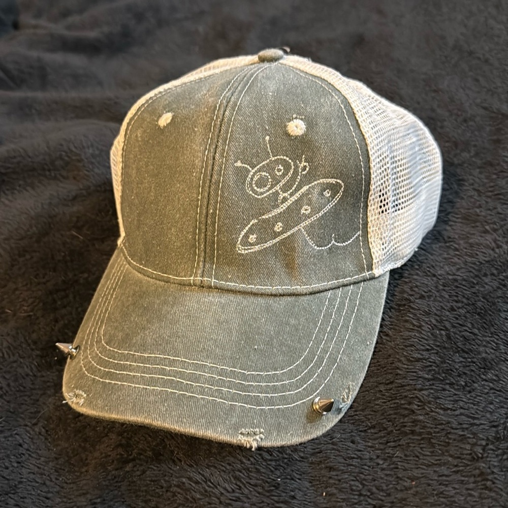 Custom trucker cap with white mesh back and alien decal.